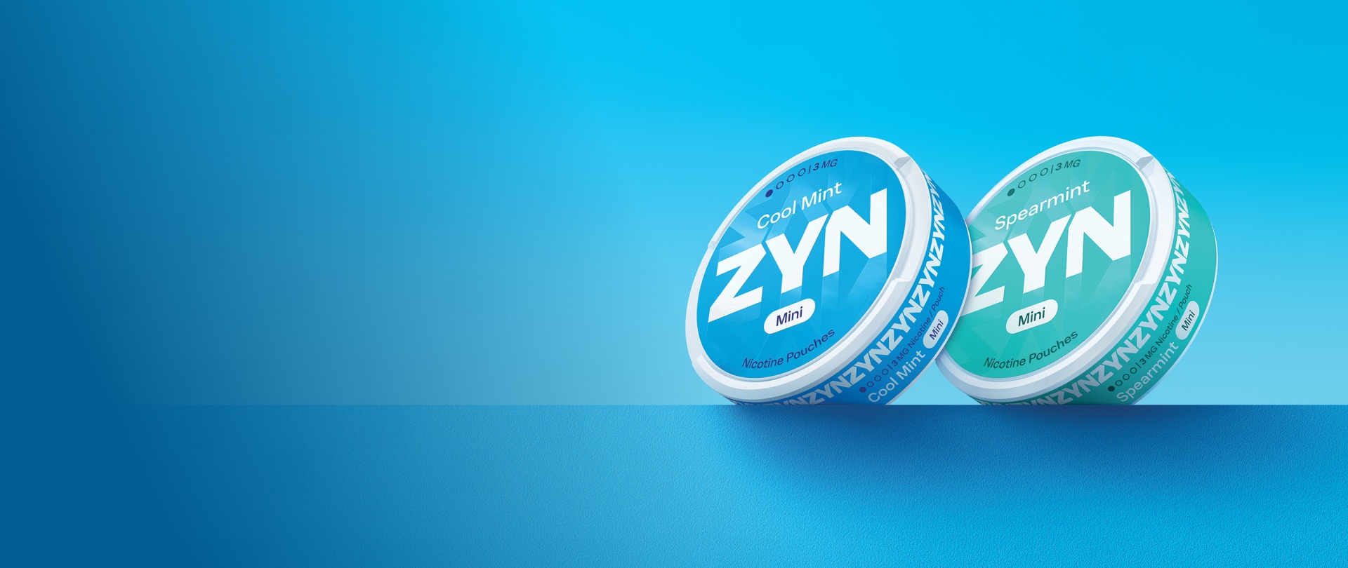 Two closed ZYN nicotine pouch cans (Cool Mint and Spearmint)