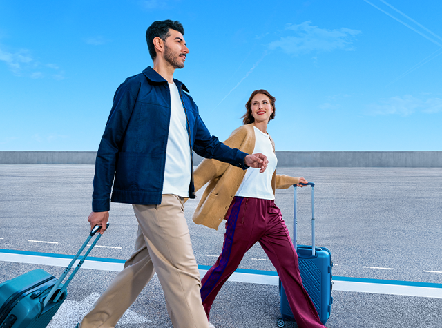 Man and woman carrying luggages