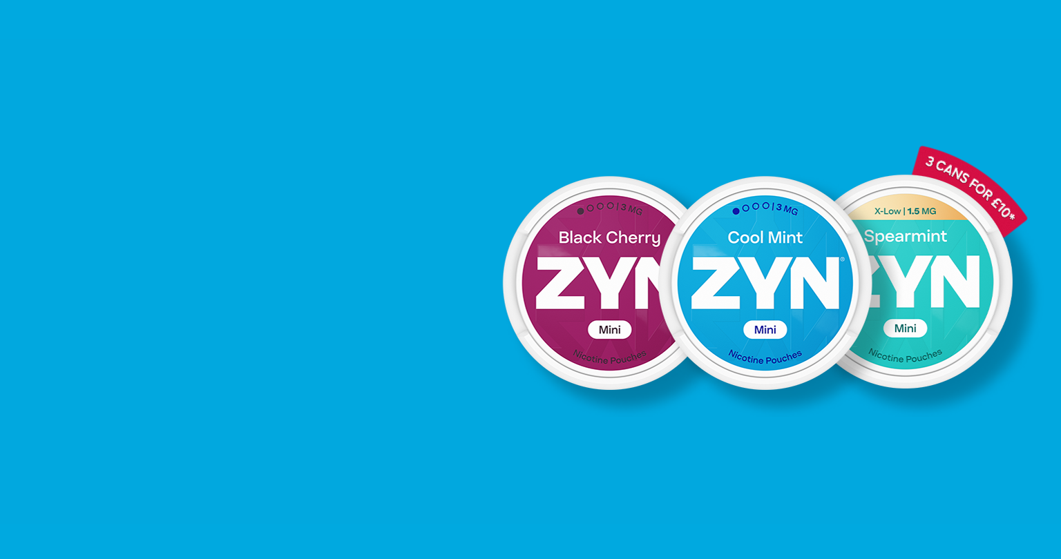 A man working on a laptop while holding an IQOS ILUMA device.