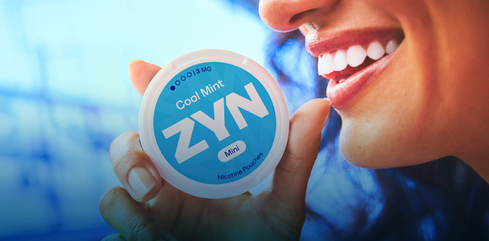 ZYN Flavors - Girl smiling while keeping a blue ZYN Cool Mint can