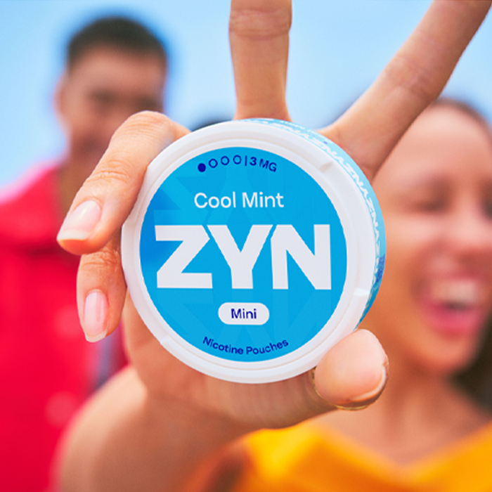 Girl holding blue ZYN can, ilustration of ZYN is a part of PMI portfolio news